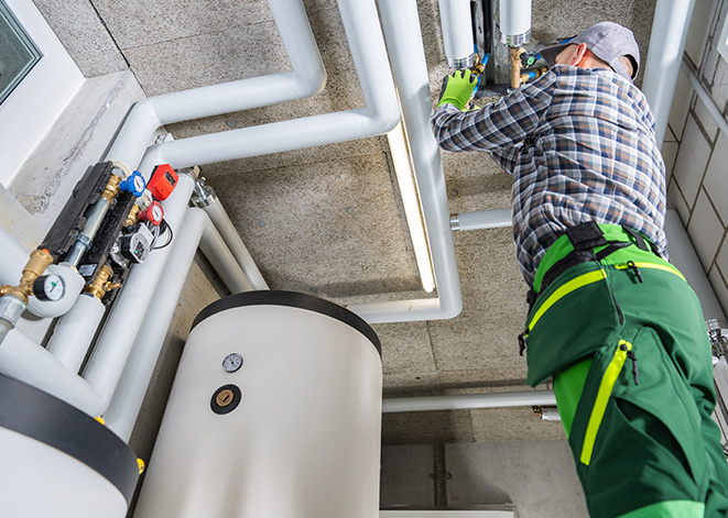 Certified HVAC technician checking air conditioning unit for Abdul HVAC, serving Maryland homes and businesses for over 20 years